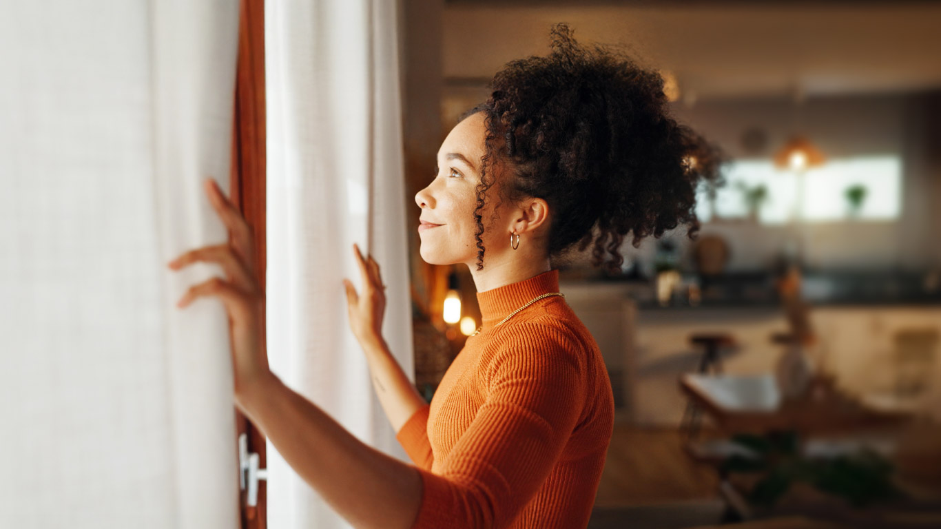 woman looking out of the window in newly renovated home