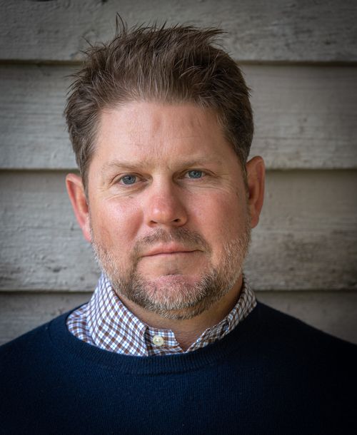 Shine Street Production Founder and CEO, James Marzak headshot with a ship lap background.
