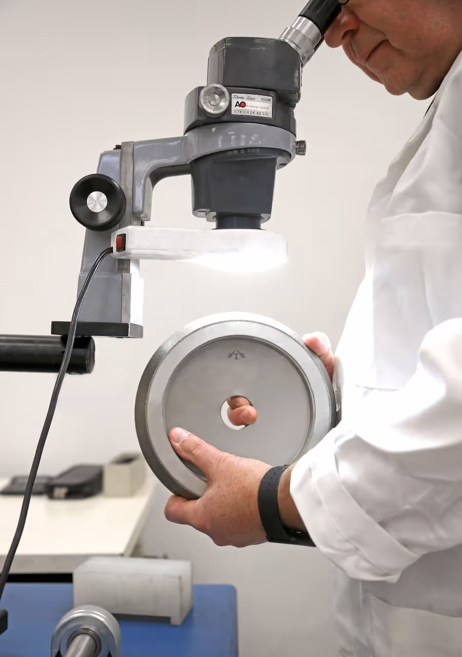 an employee closely examining a custom Abrasive Technology product