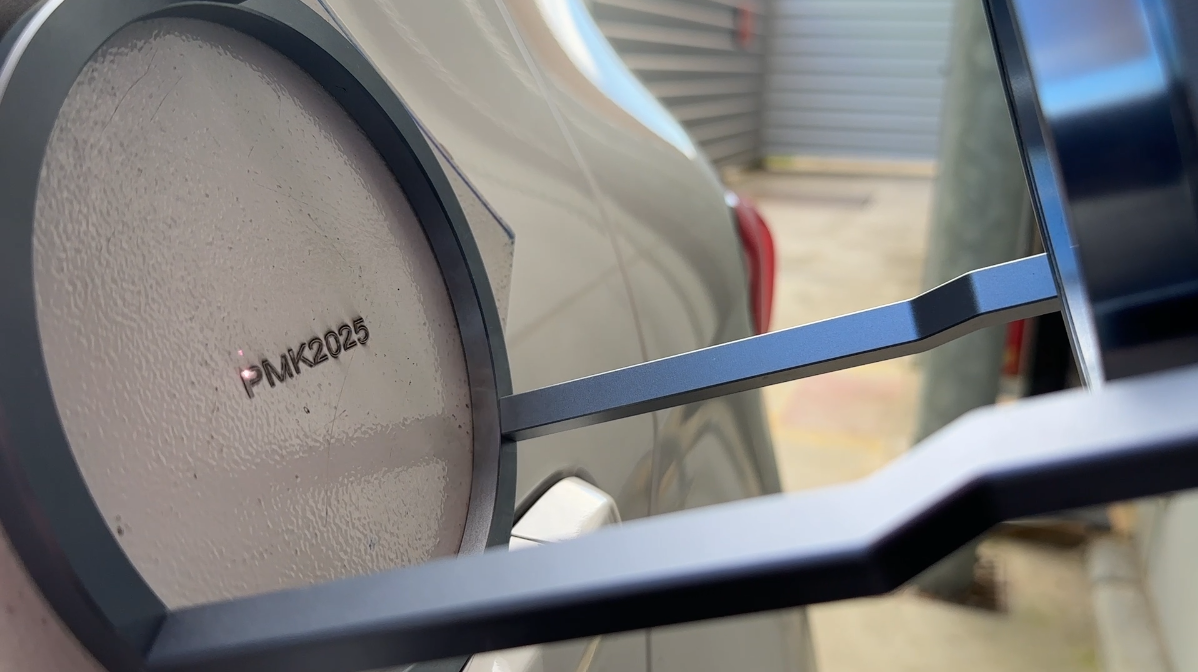 Gravadora a laser portátil realizando a gravação em um carro.