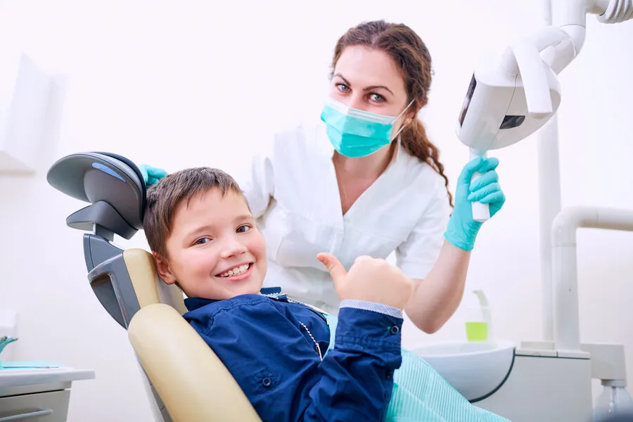 Little boy is smiling in the dental chair at the best pediatric dentist in Anchorage