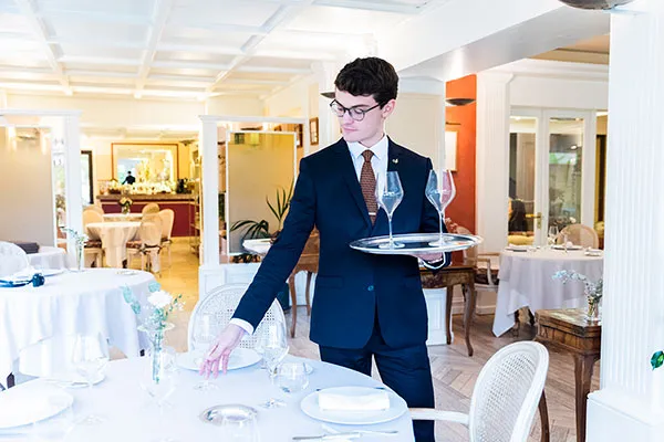 un étudiant à la mise en place des tables dans un restaurant