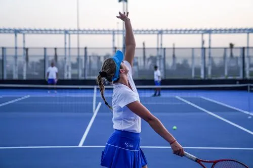 A professional women tennis player on a blue court at Rafa Nadal Academy Kuwait
