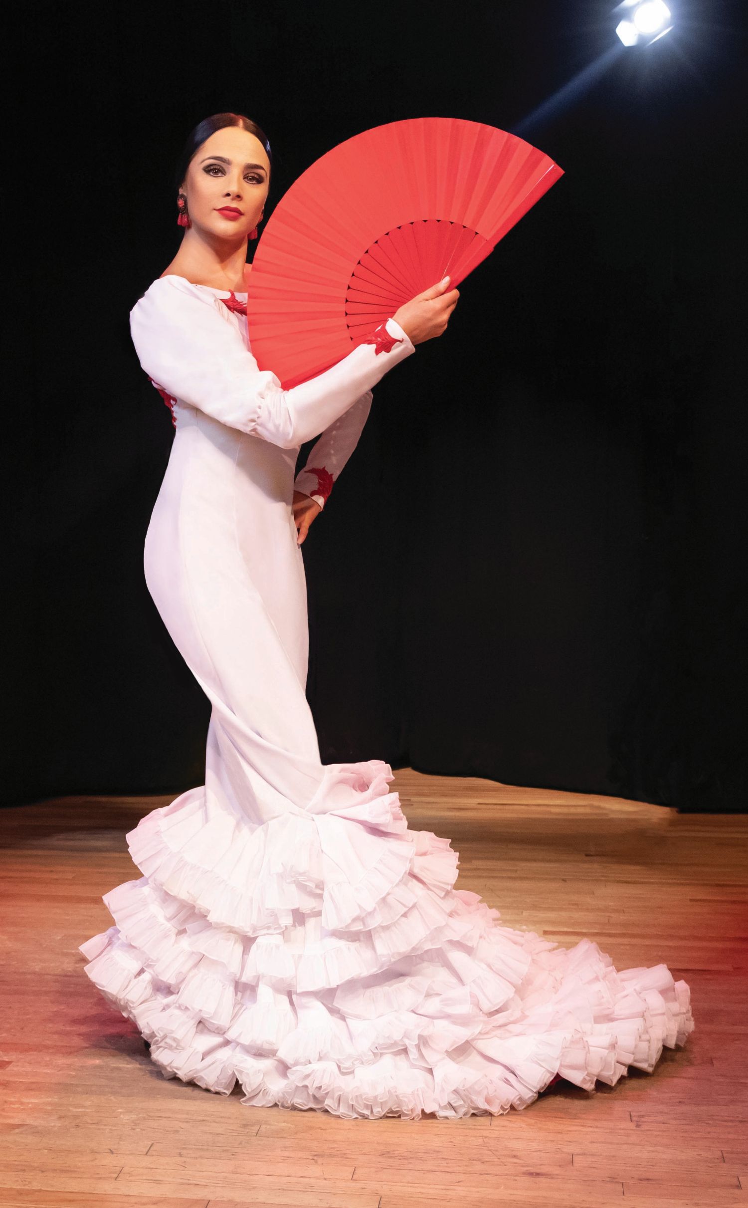La Emi Flamenco dancer in white dress with red fan