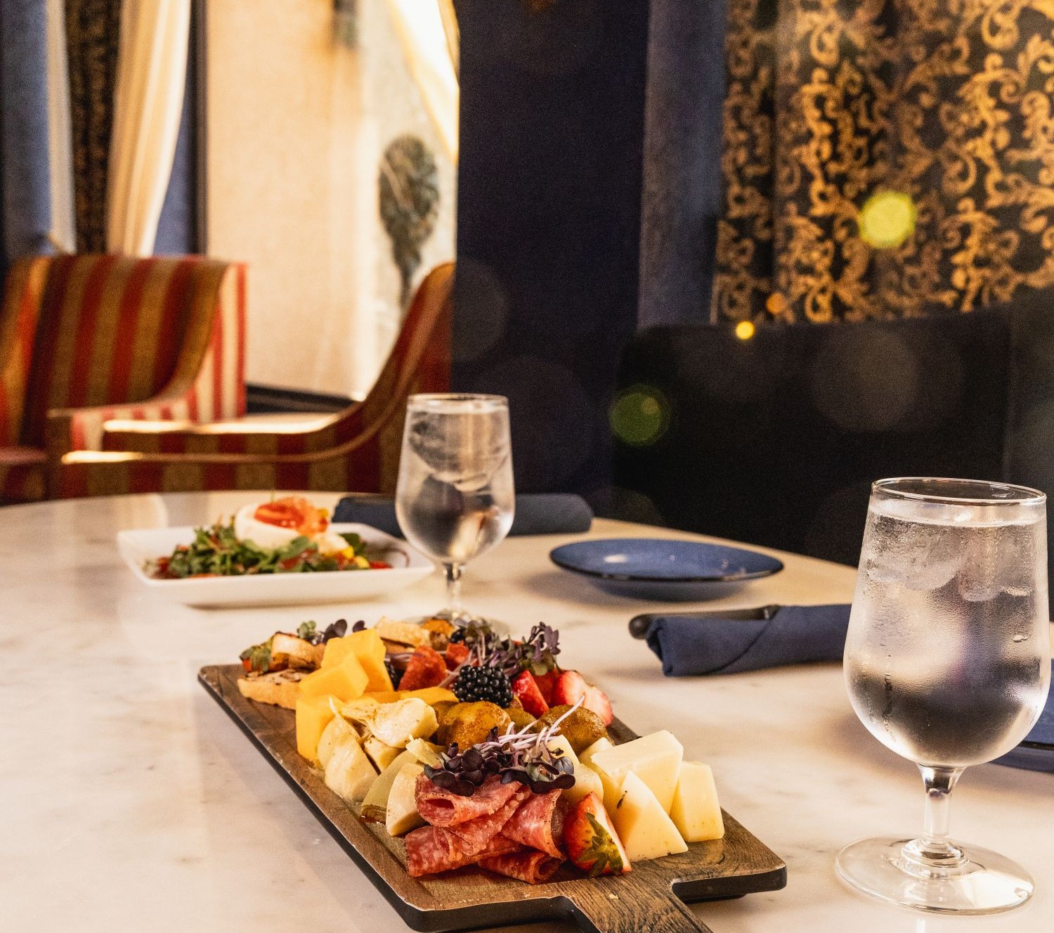 Mezcla restaurant with tables and a charcuterie plate