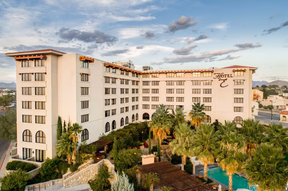 Aerial shot of Hotel Encanto exterior with palm trees