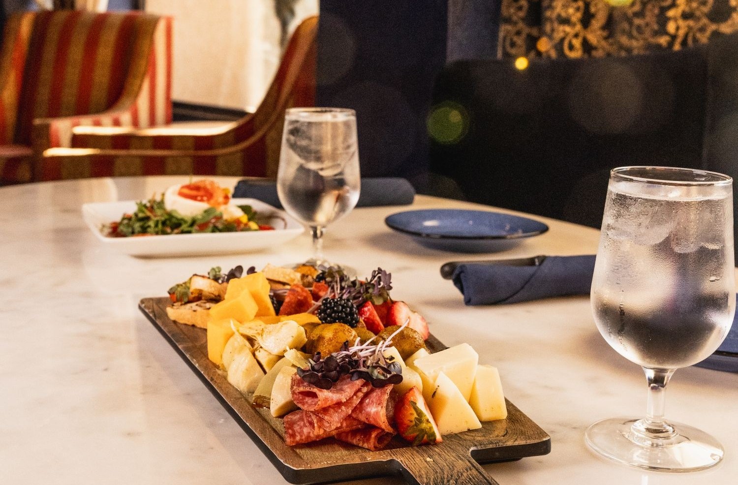 Mezcla restaurant with tables and a charcuterie plate