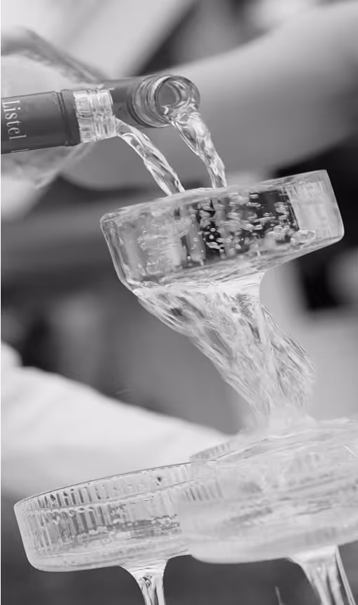 a person pouring water into a glass