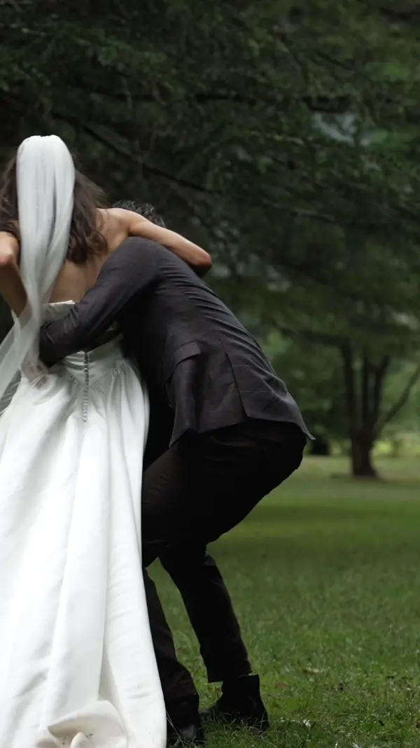 a man and woman hugging in a park