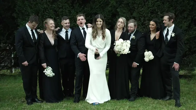 a group of people in black suits and white dresses