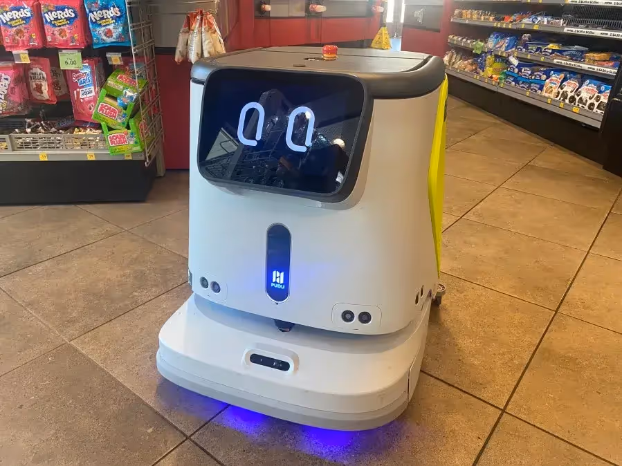 A Pudu Floor Cleaning Robot in a QuikTrip