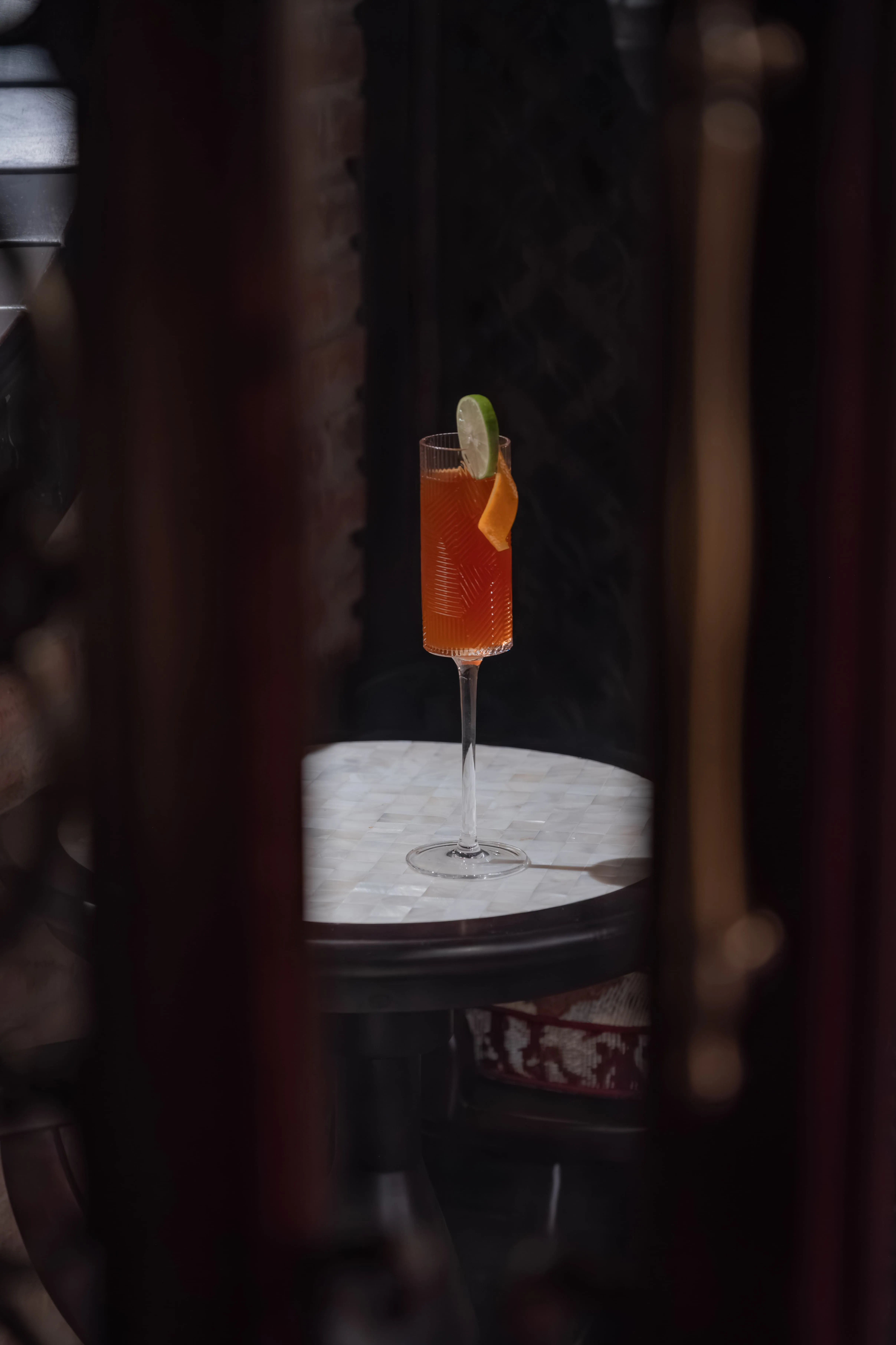 A cocktail glass on the uniquely mother-of-pearl inlaid table of Van Xuan Bar – a refined bar in Hue