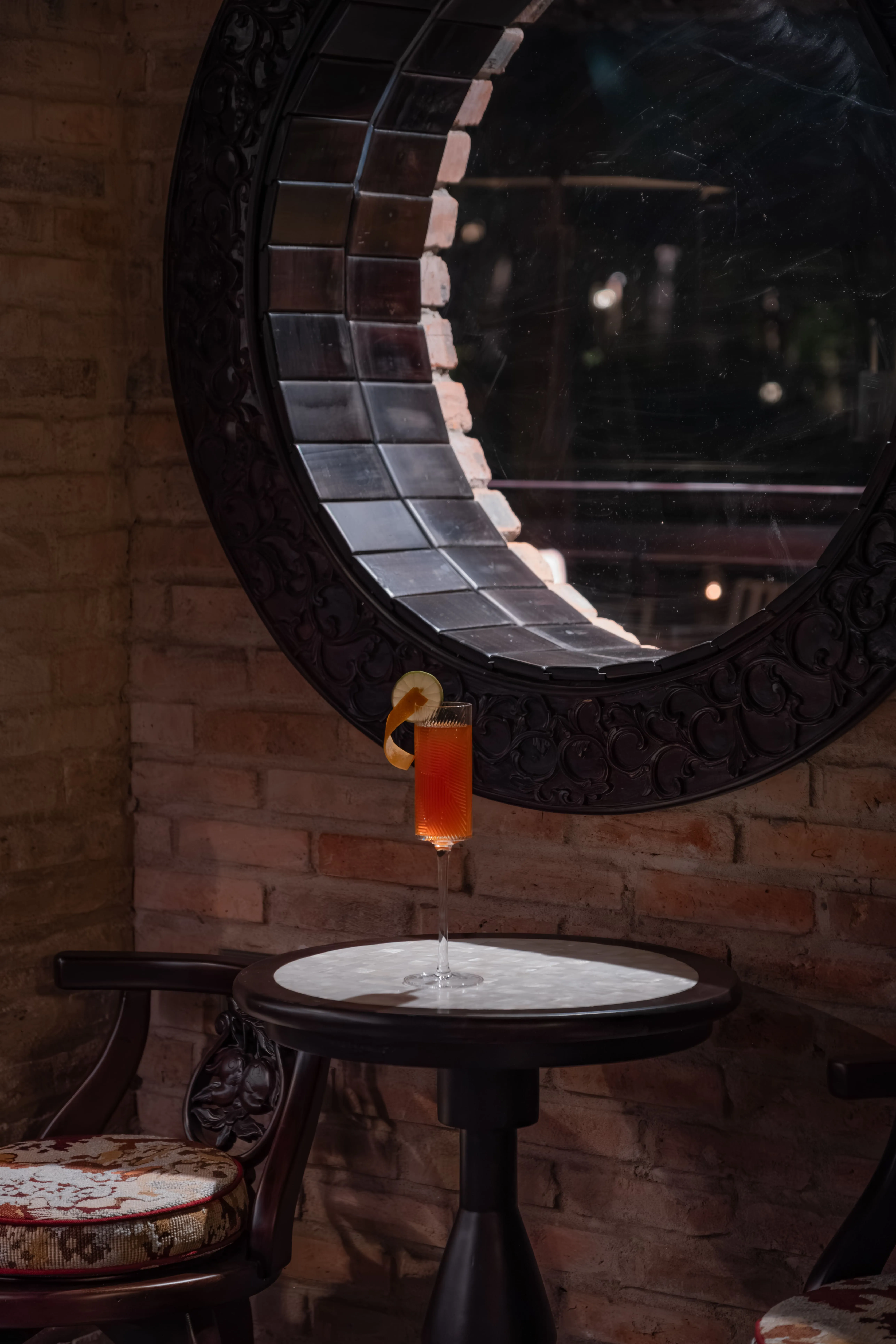 A cocktail glass on the uniquely mother-of-pearl inlaid table of Van Xuan Bar – a refined bar in Hue
