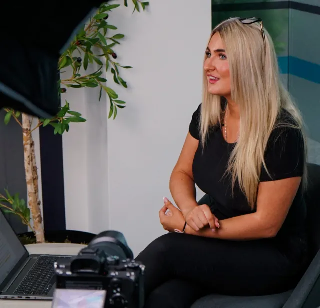 Laura Wild Search Consultant sitting in front of a laptop.