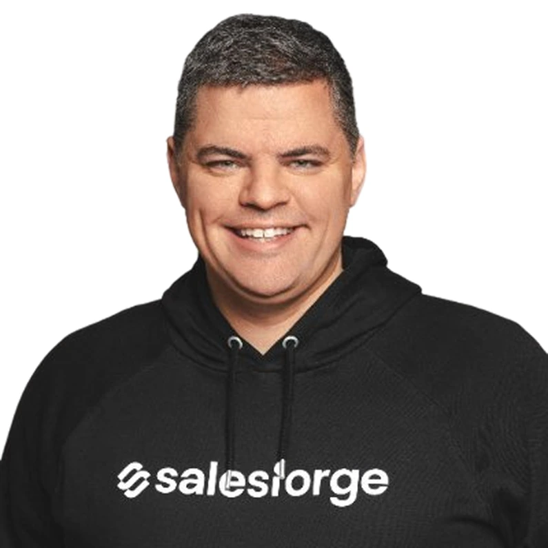 Smiling man with short dark hair wearing a black hoodie with the word 'salesiorge' on it.
