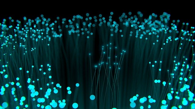 Glowing blue fiber optic lights creating abstract network-like pattern