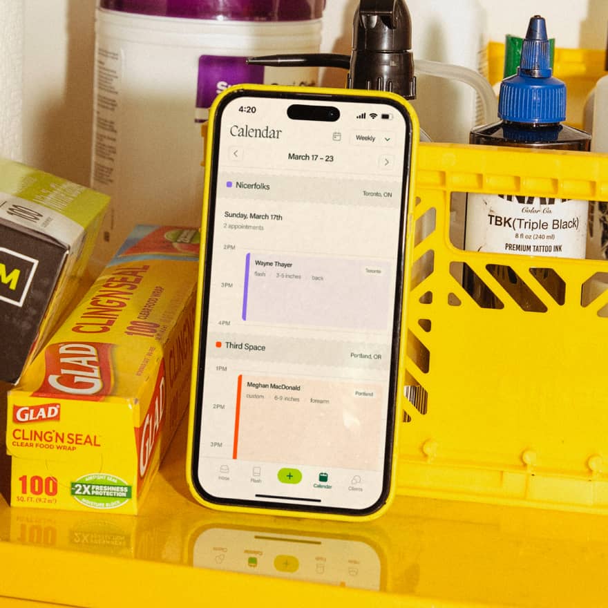 Phone with screen showing an artist's work calendar on Venue Ink