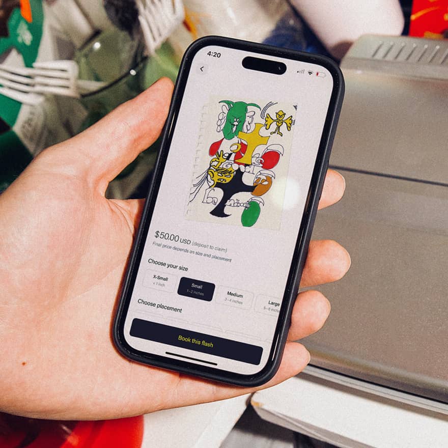 Hands holding a phone browsing an artist's flash on Venue Ink