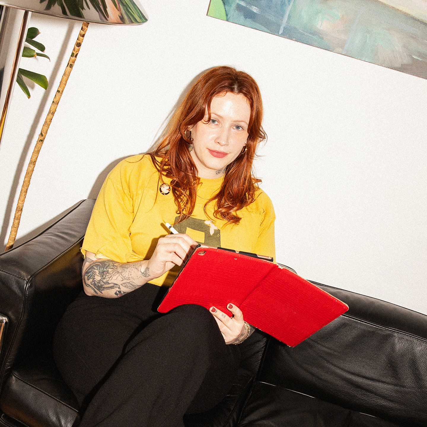 Heavily tattooed person browsing on their cellphone