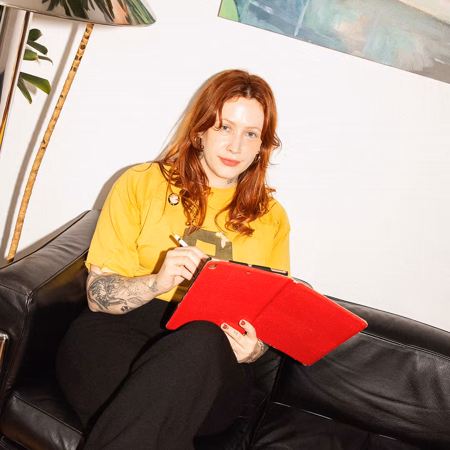 Heavily tattooed person browsing on their cellphone