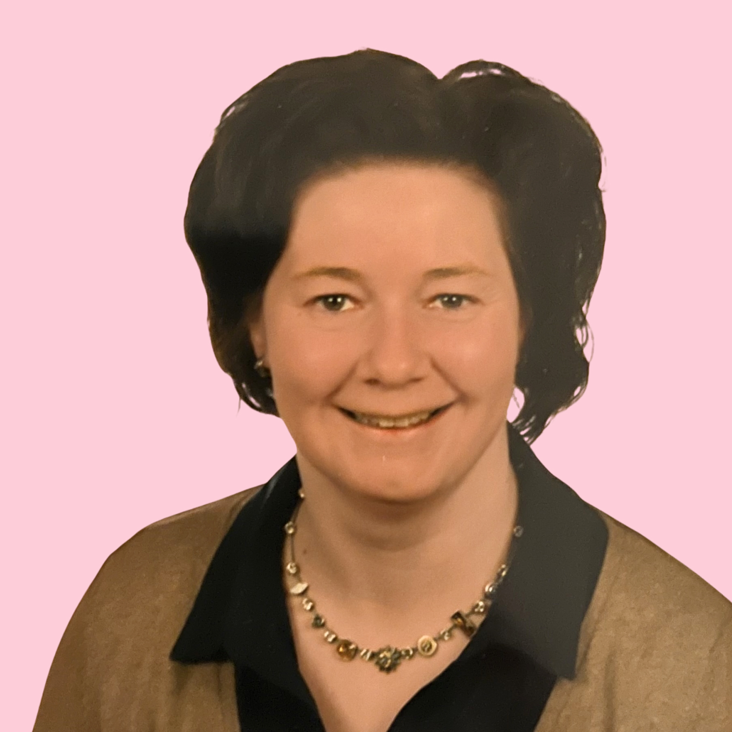 Michala hat braune, voluminöse Haare und lächelt in die Kamera