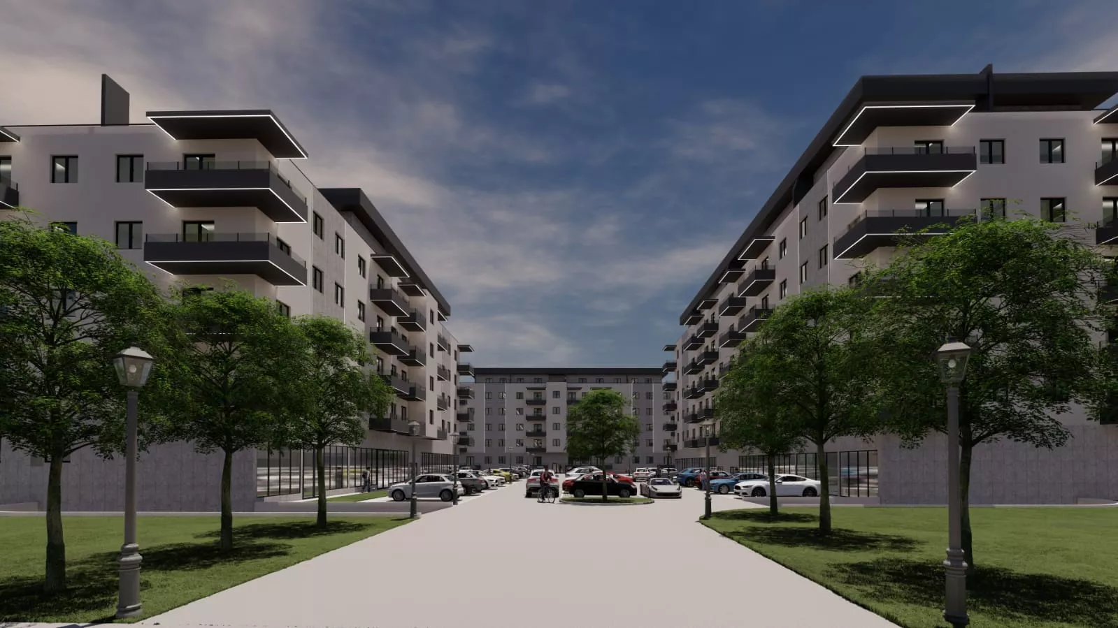 Modern apartment complex with symmetrical buildings, front parking lot with cars, central tree island, and surrounding green trees under a partly cloudy sky.