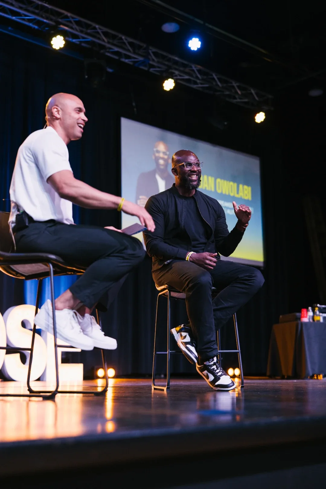 dan on stage speaking with another man