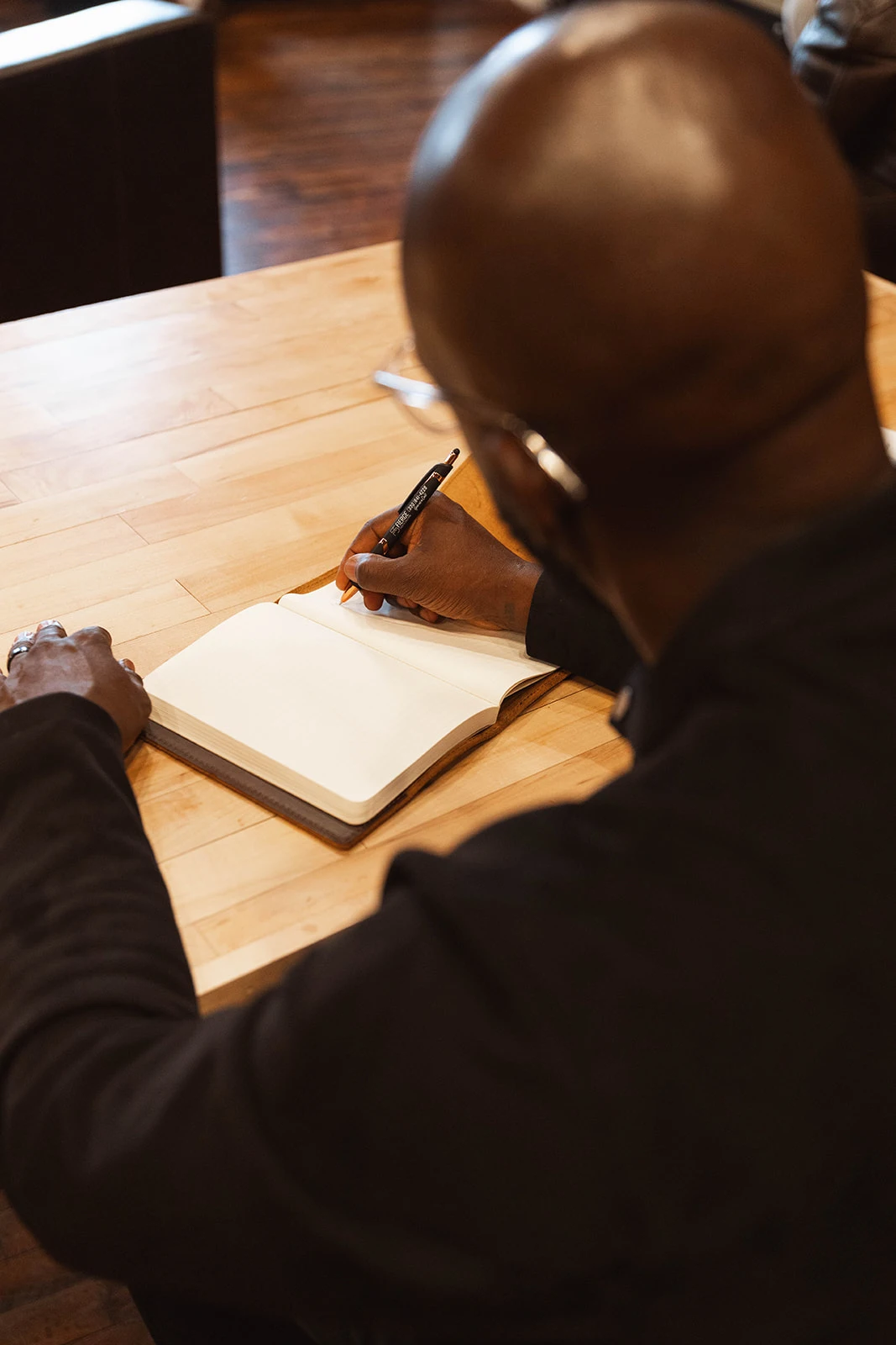 dan writing with a pen on a notebook