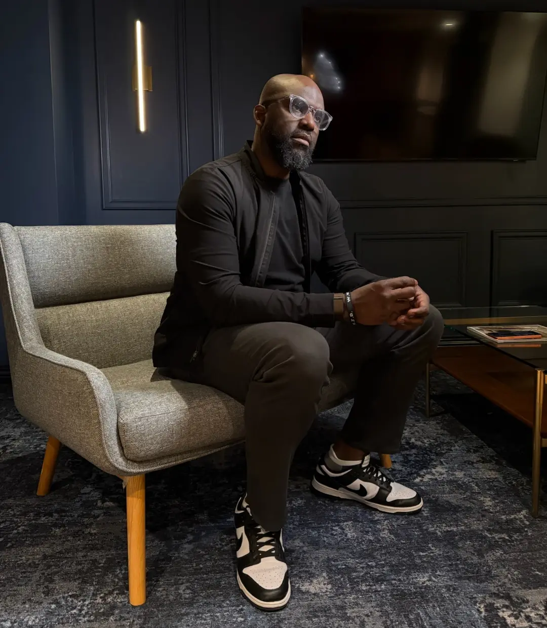 dan owolabi sitting in chair at podcast set