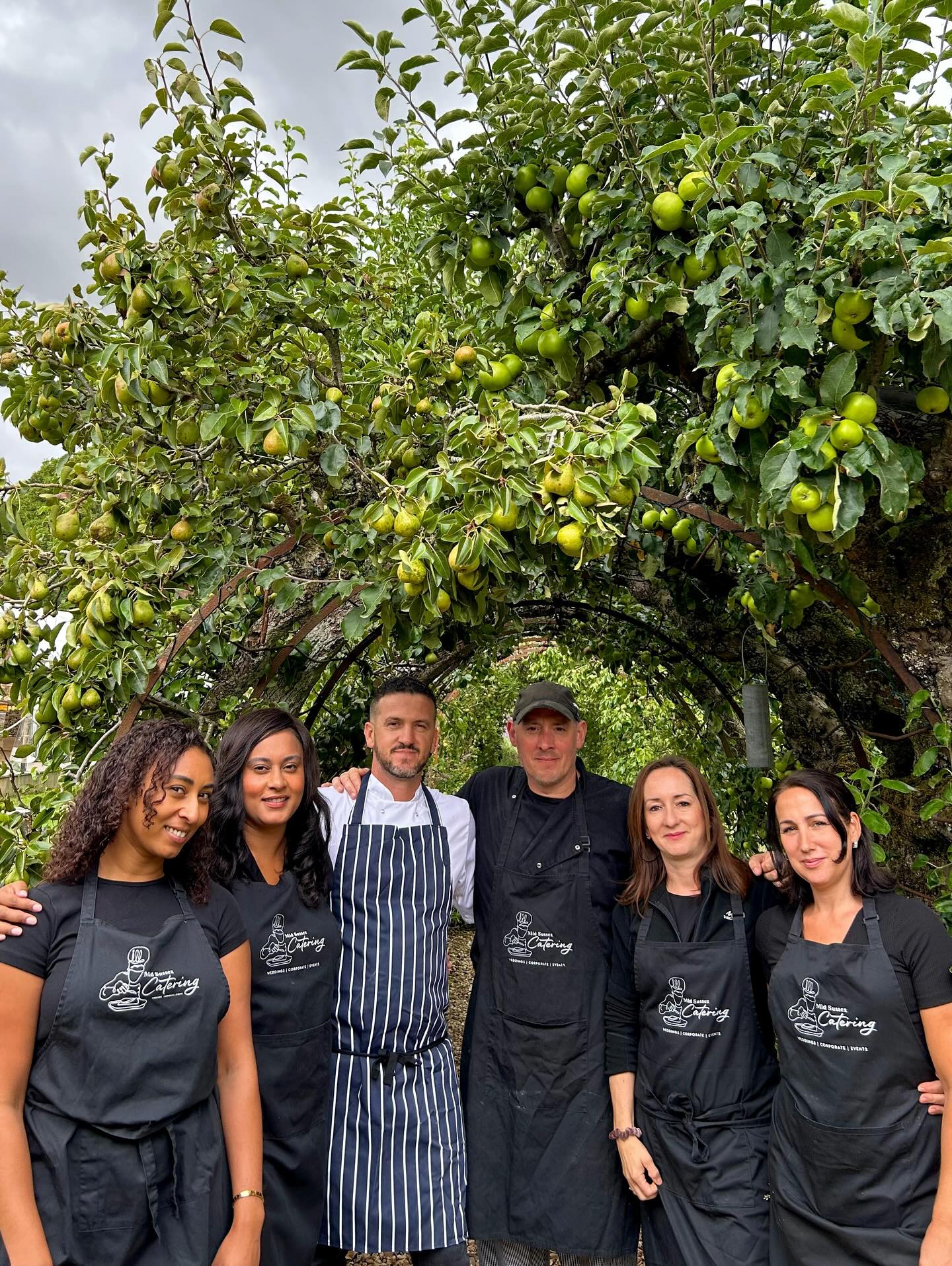 The midsussex Catering team stand under a tree