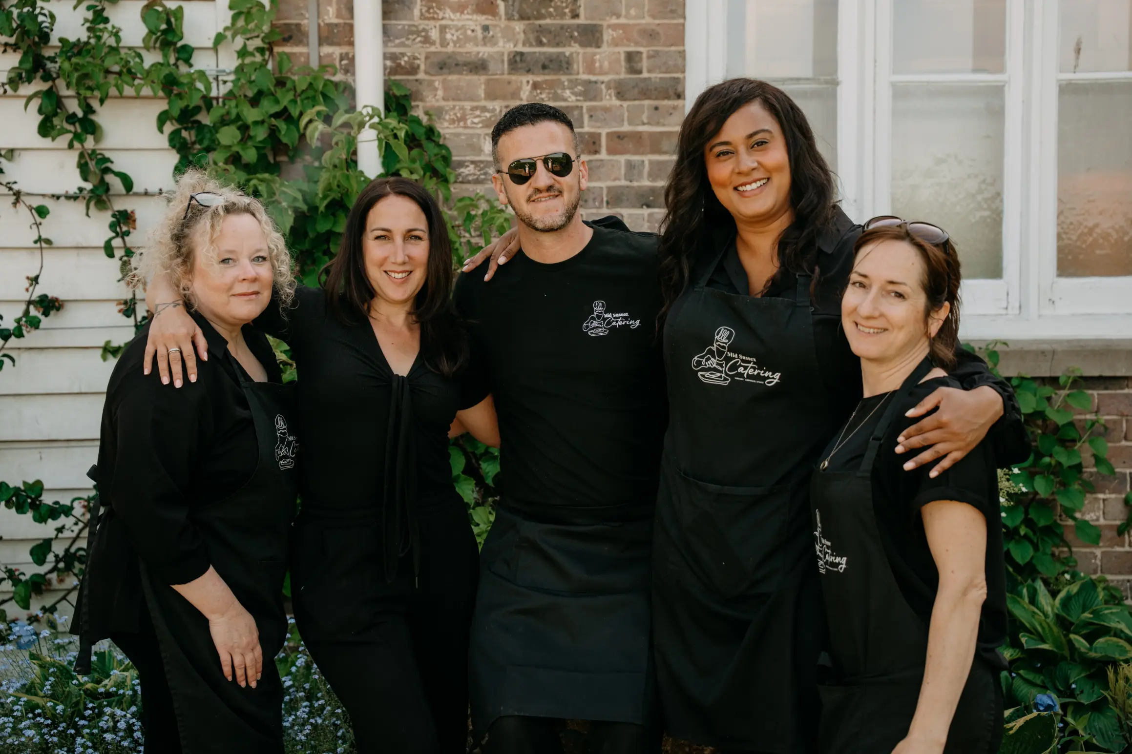 The midsussex Catering team stand under a tree