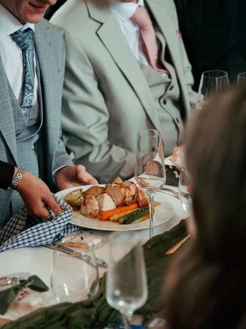 A selection of meats and crackling and stuffing balls with rosemary decorating the dish