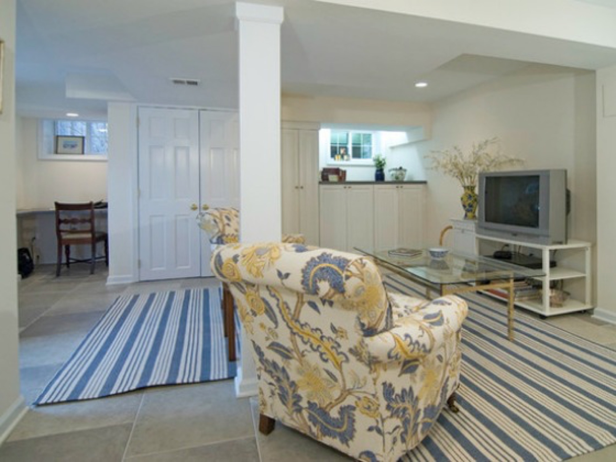 A basement finished with guest bedrooms, an office work area and a bright family room.