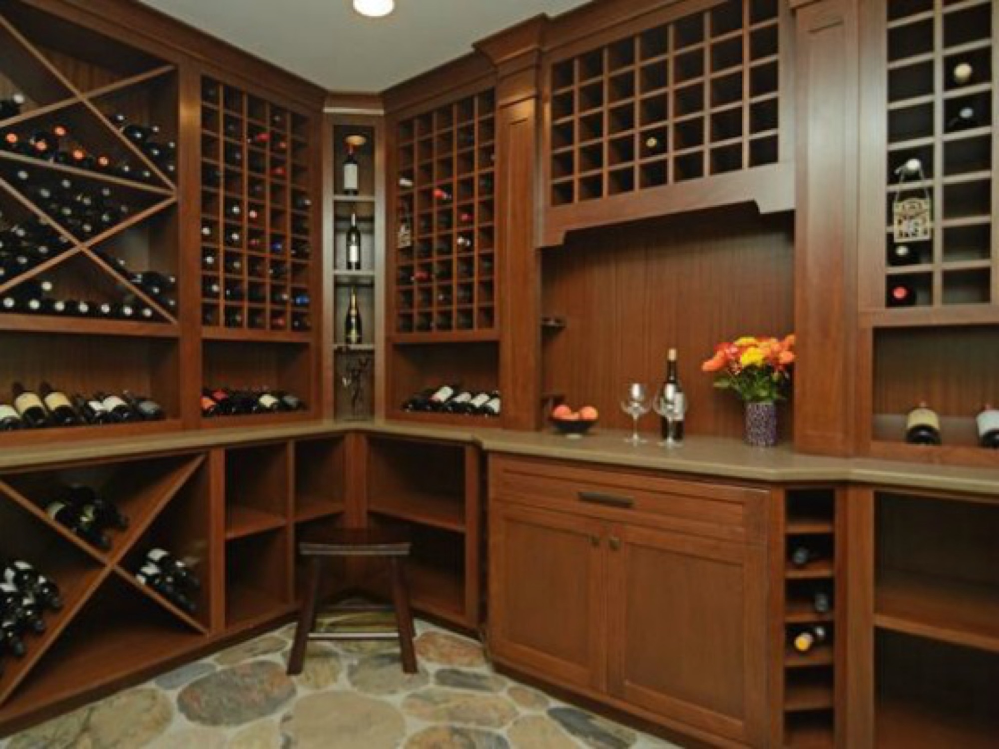 A wall-to-wall wood wine cellar with a built-in tasting counter.