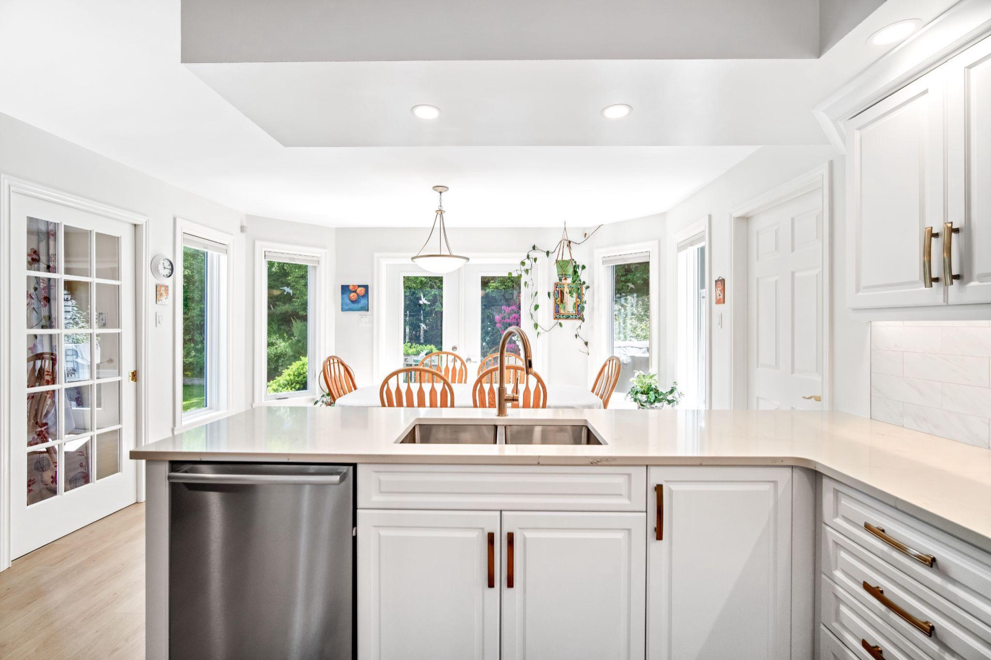 A dated 20-year-old layout reworked into an open, entertaining-friendly main floor for a couple whose kids had moved out.