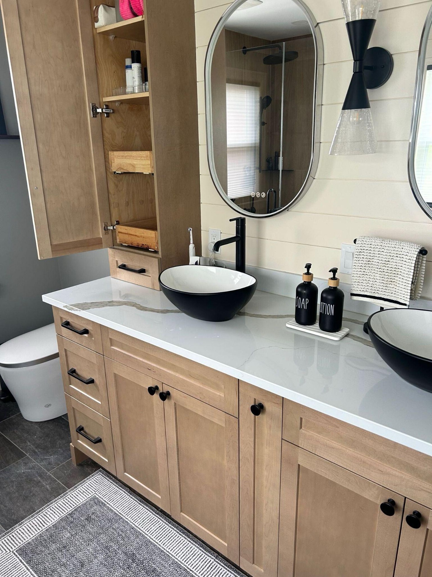 A dated primary bathroom turned into a relaxing retreat that pairs contemporary design with warm, natural materials.