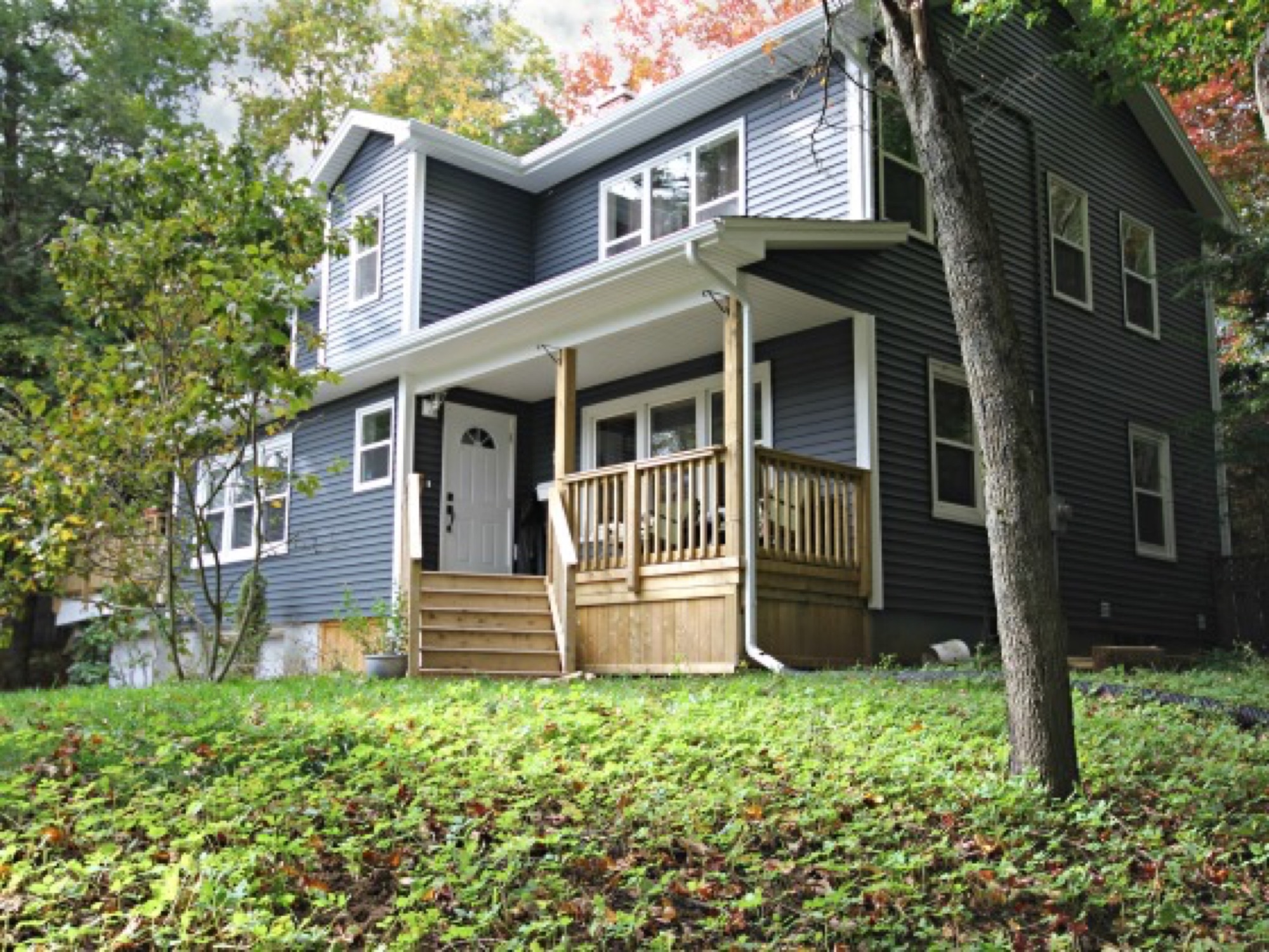 A second storey that added two bedrooms and a primary suite, with new siding, a porch and a deck to tie it together.