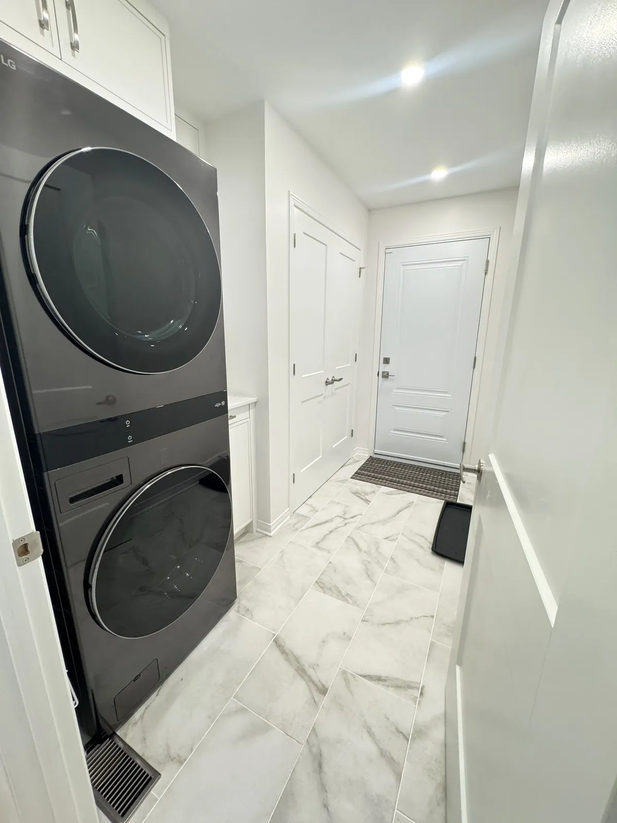 Laundry moved to a mudroom with stacked washer and dryer
