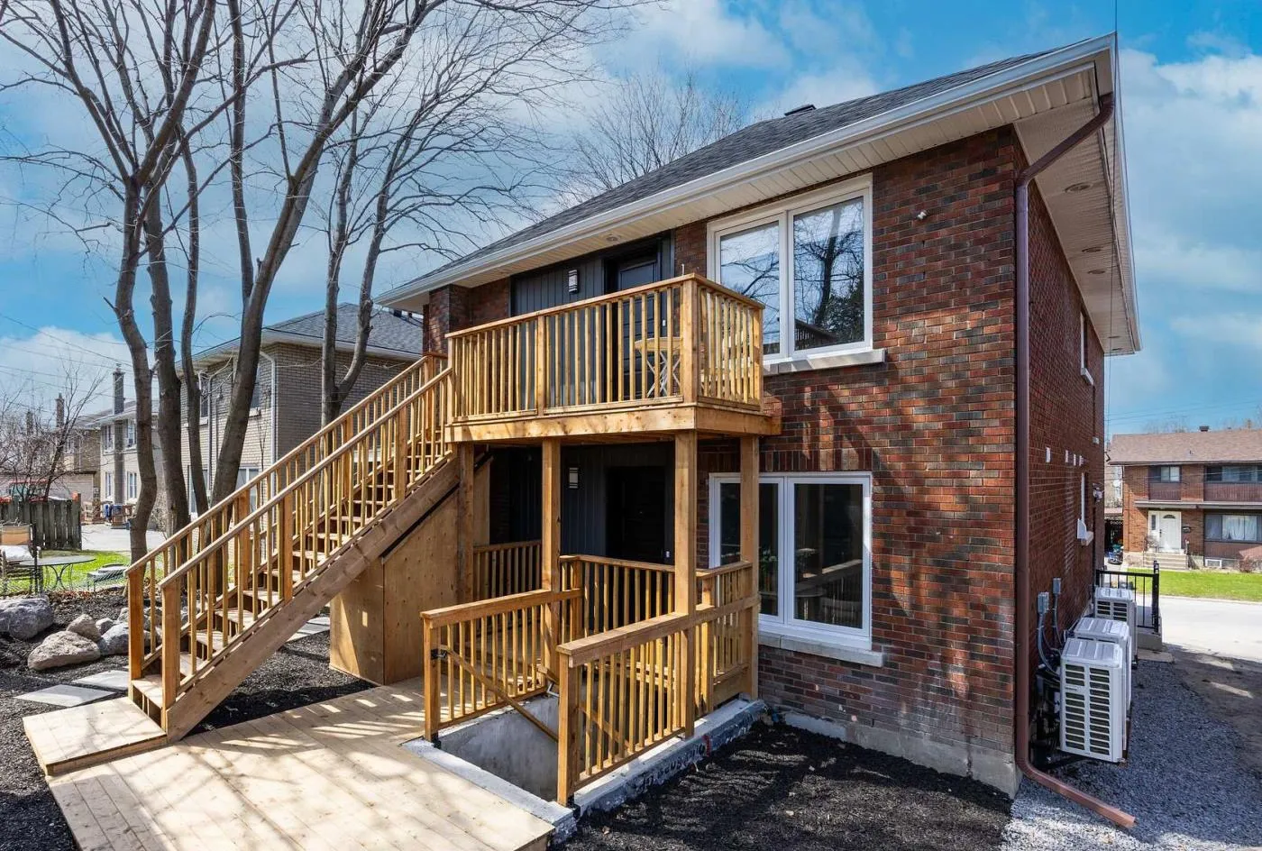 New rear stairs and decks with a walk-down entrance to the basement suites