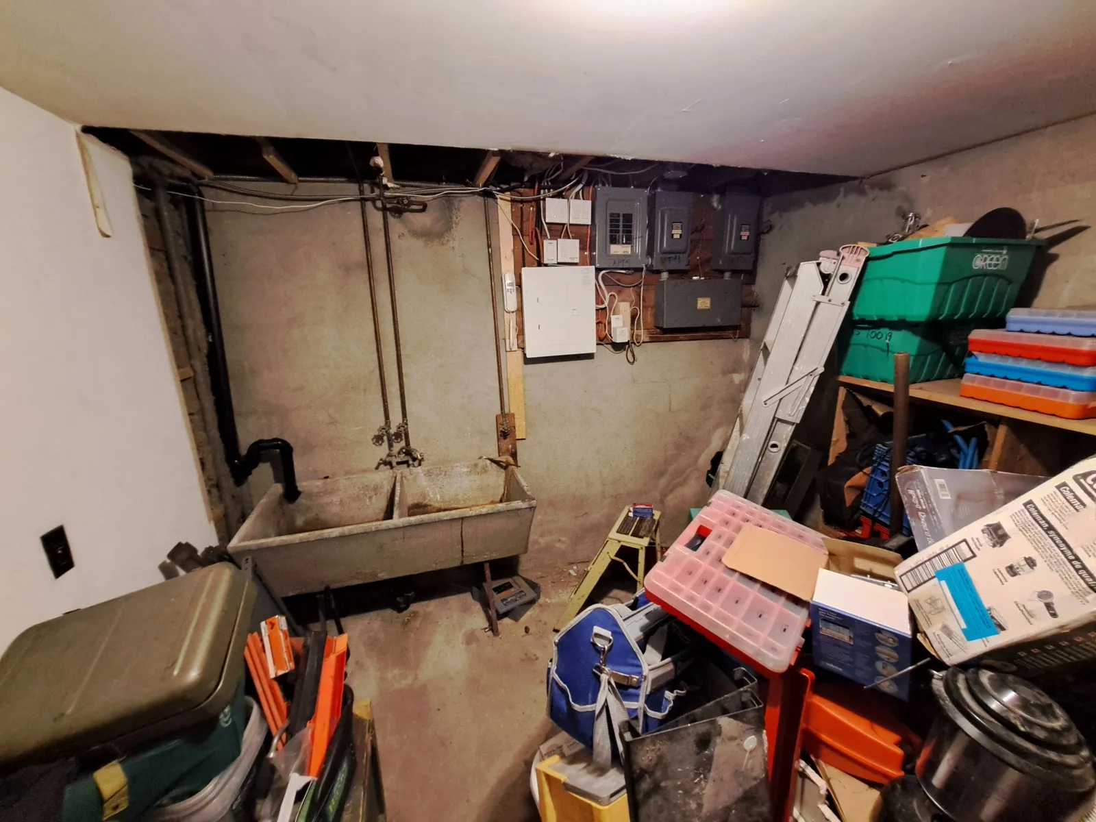 Unfinished basement laundry and utility room before the conversion