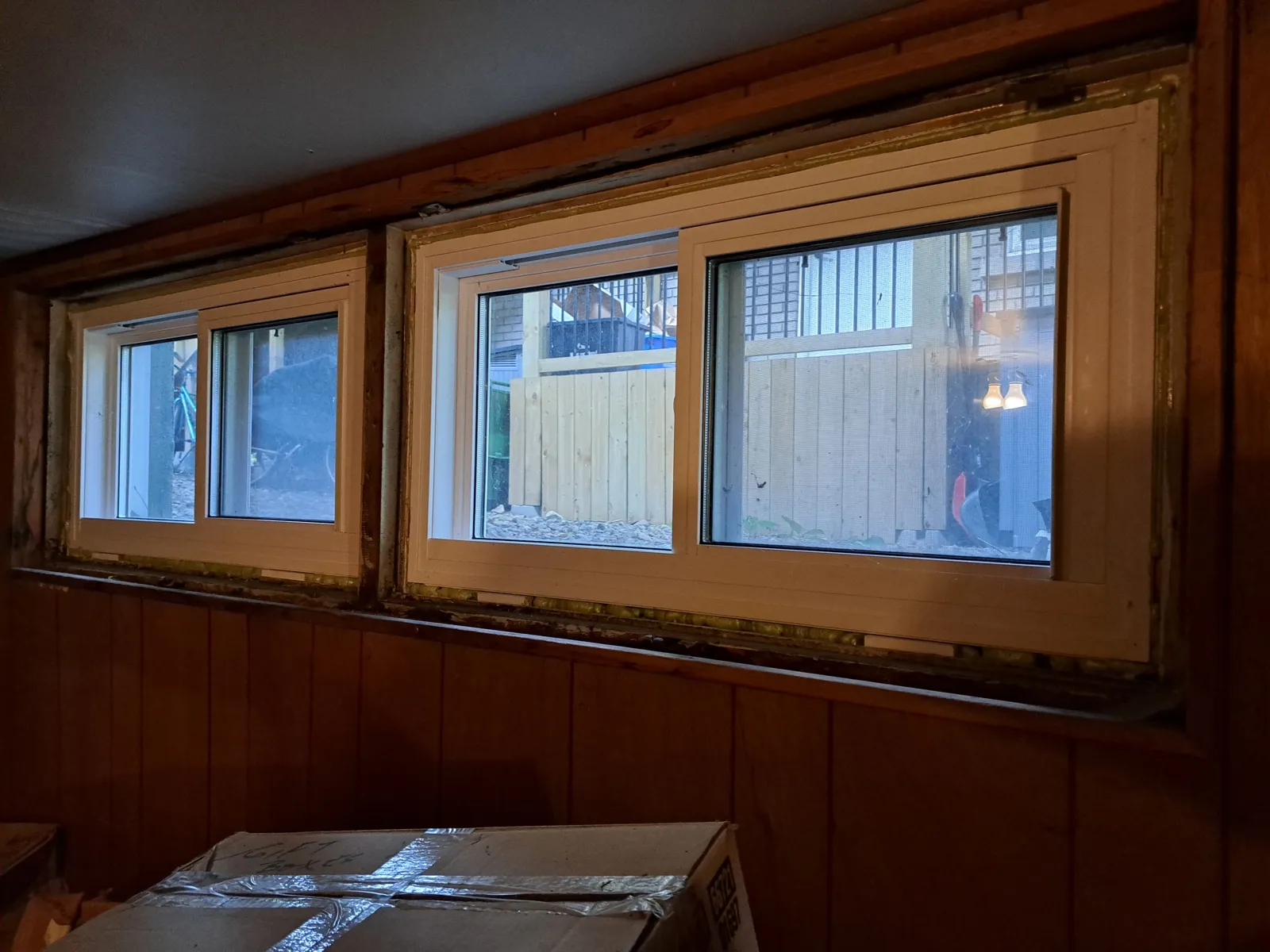 Dated wood-panelled basement room before the conversion
