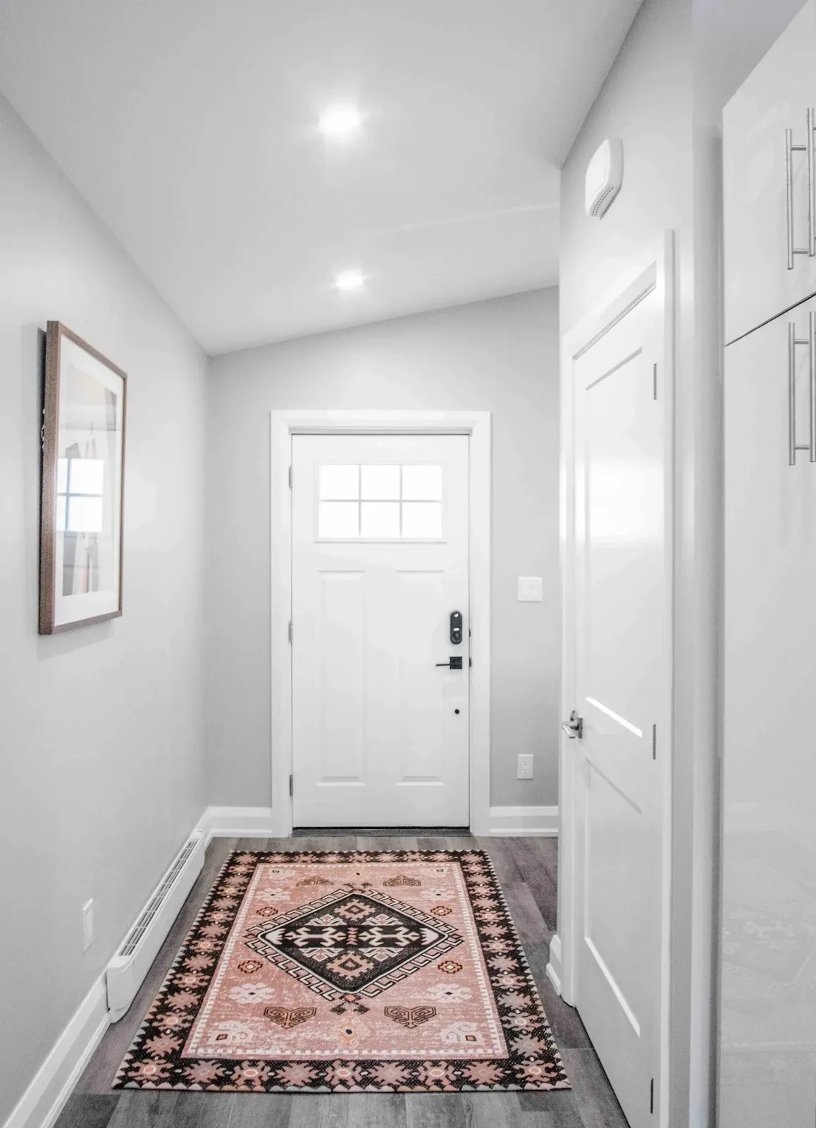 Coach house entry with a closet and pot lights
