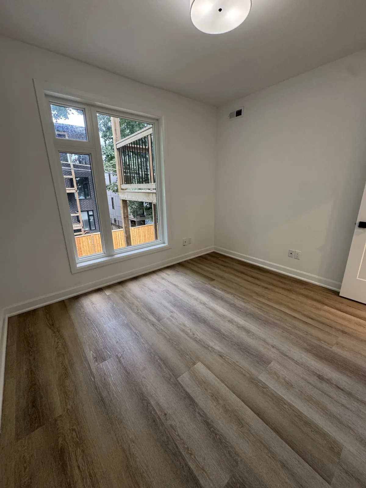 Unit bedroom with a tall black-framed window