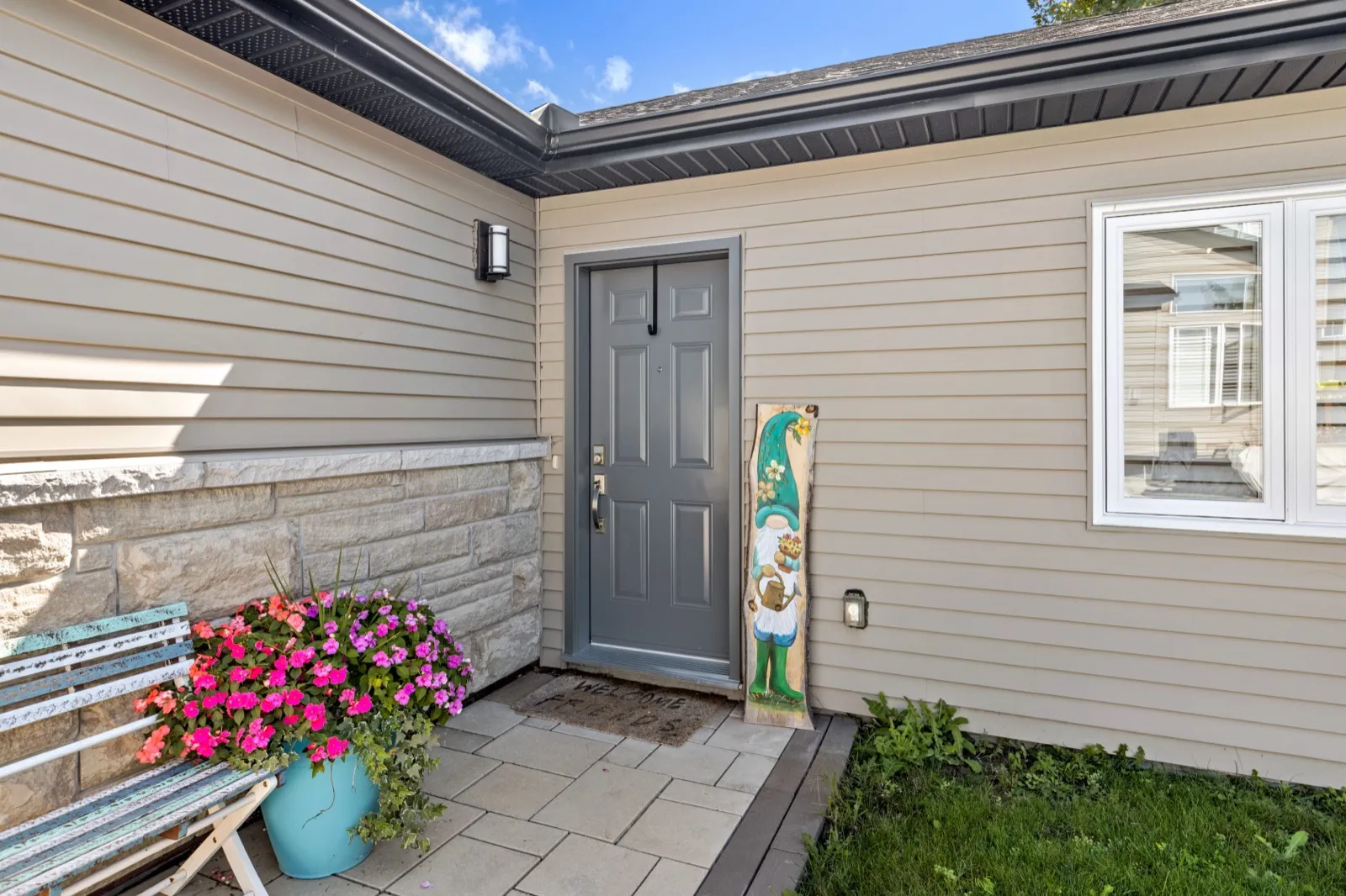 Private coach house entrance with a keypad lock on a paver patio
