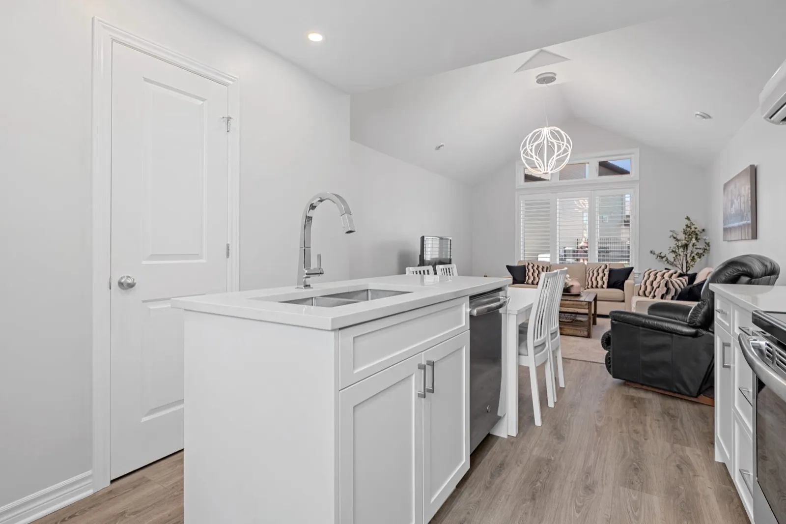 Kitchen island sink with a view into the coach house living area