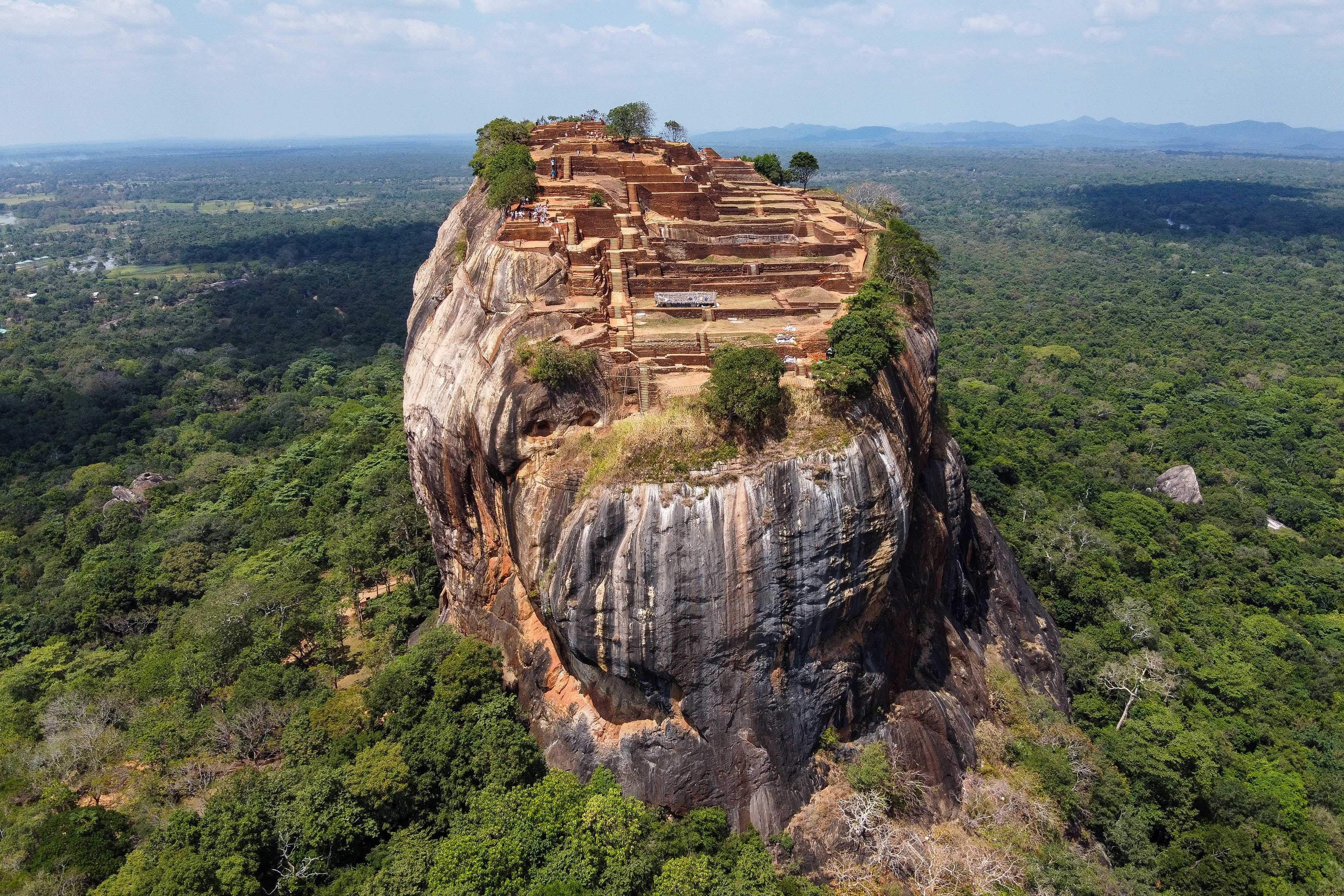 Aerial view of Sigiriya Rock Fortress rising above dense jungle in central Sri Lanka