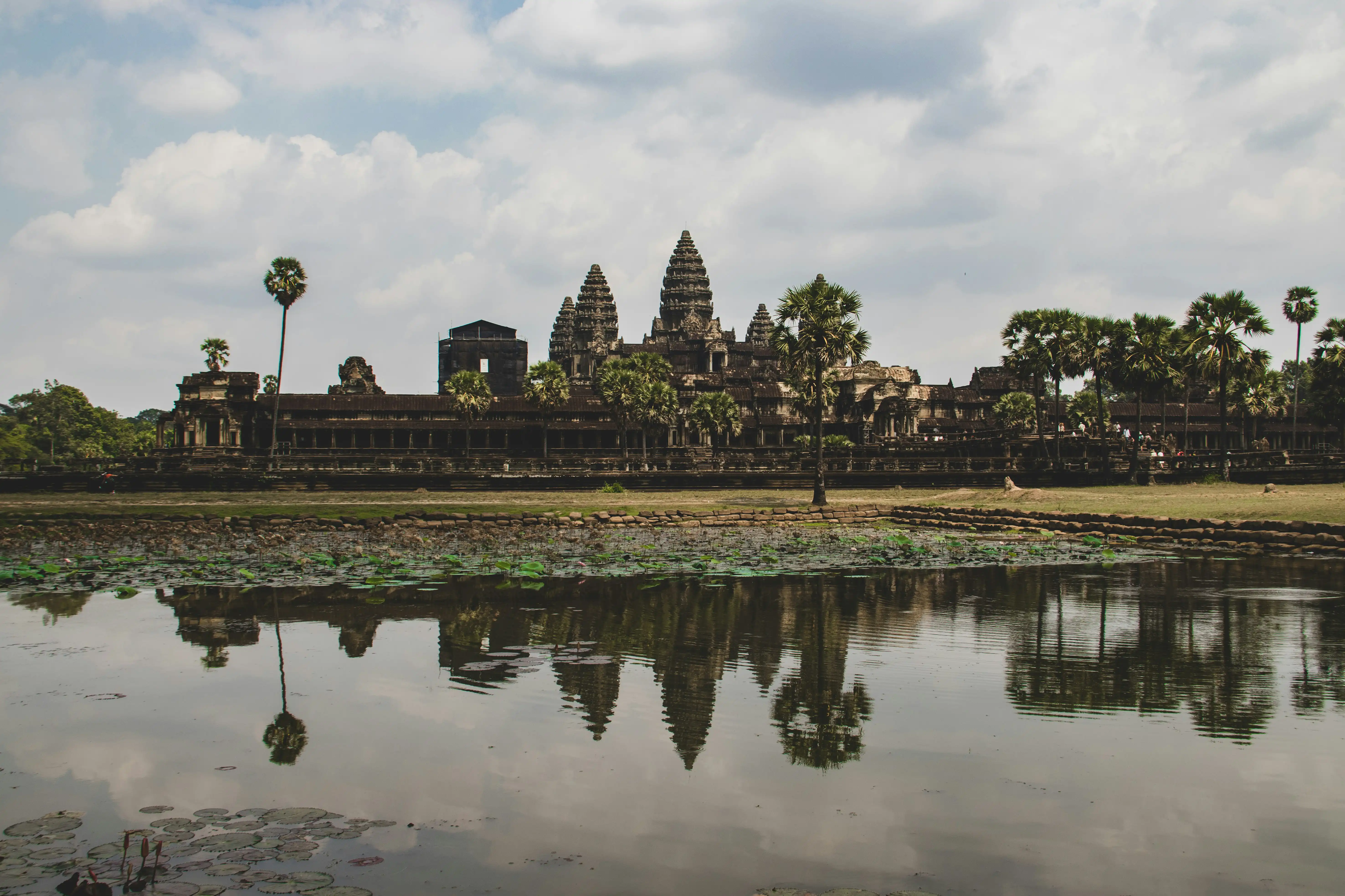 The temple towers of Angkor Wat reflected in a still pond in Cambodia