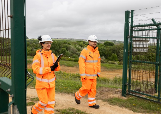 Two operators walking onto site