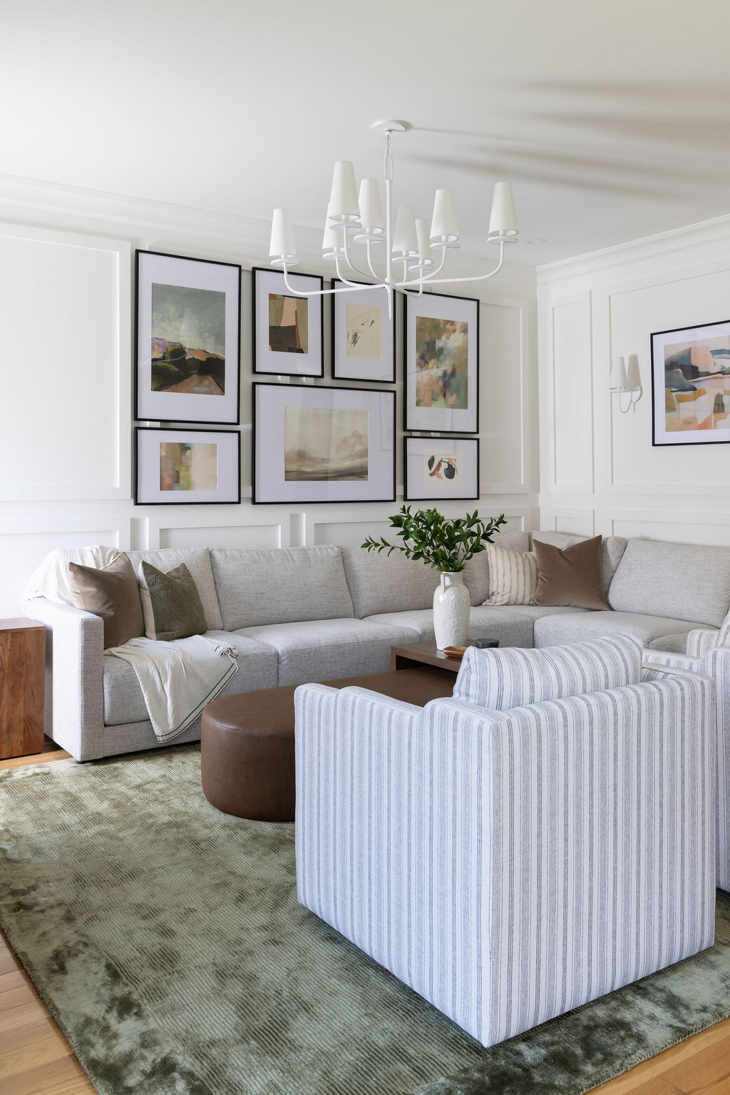 contemporary living room with gallery wall and green rug