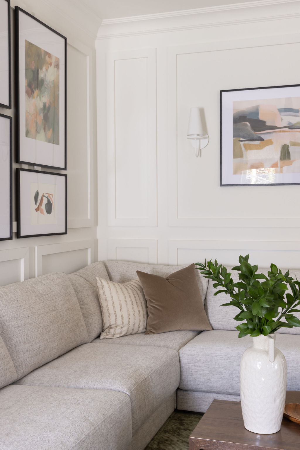 large sofa, gallery wall, unique lighting, matte white light